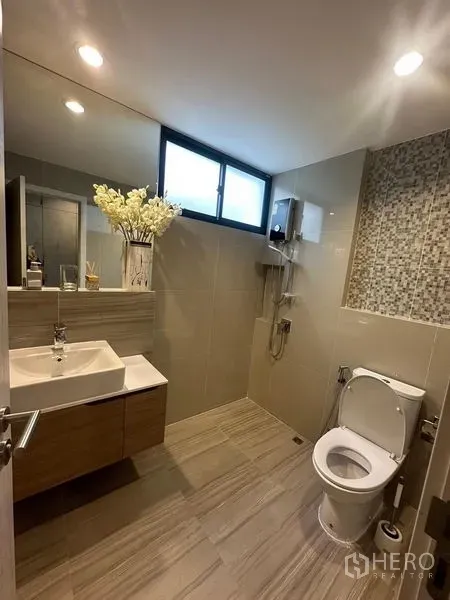 Townhouse for sale in Saphan Sung, Bangkok - Contemporary bathroom with vanity, toilet, shower and mosaic feature wall beneath a frosted window.