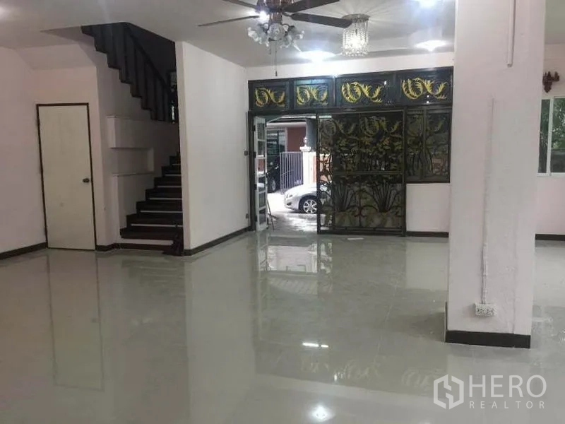 Detached House for rent in Chatuchak, Bangkok - Open-plan ground floor with staircase and ornate metal front door.
