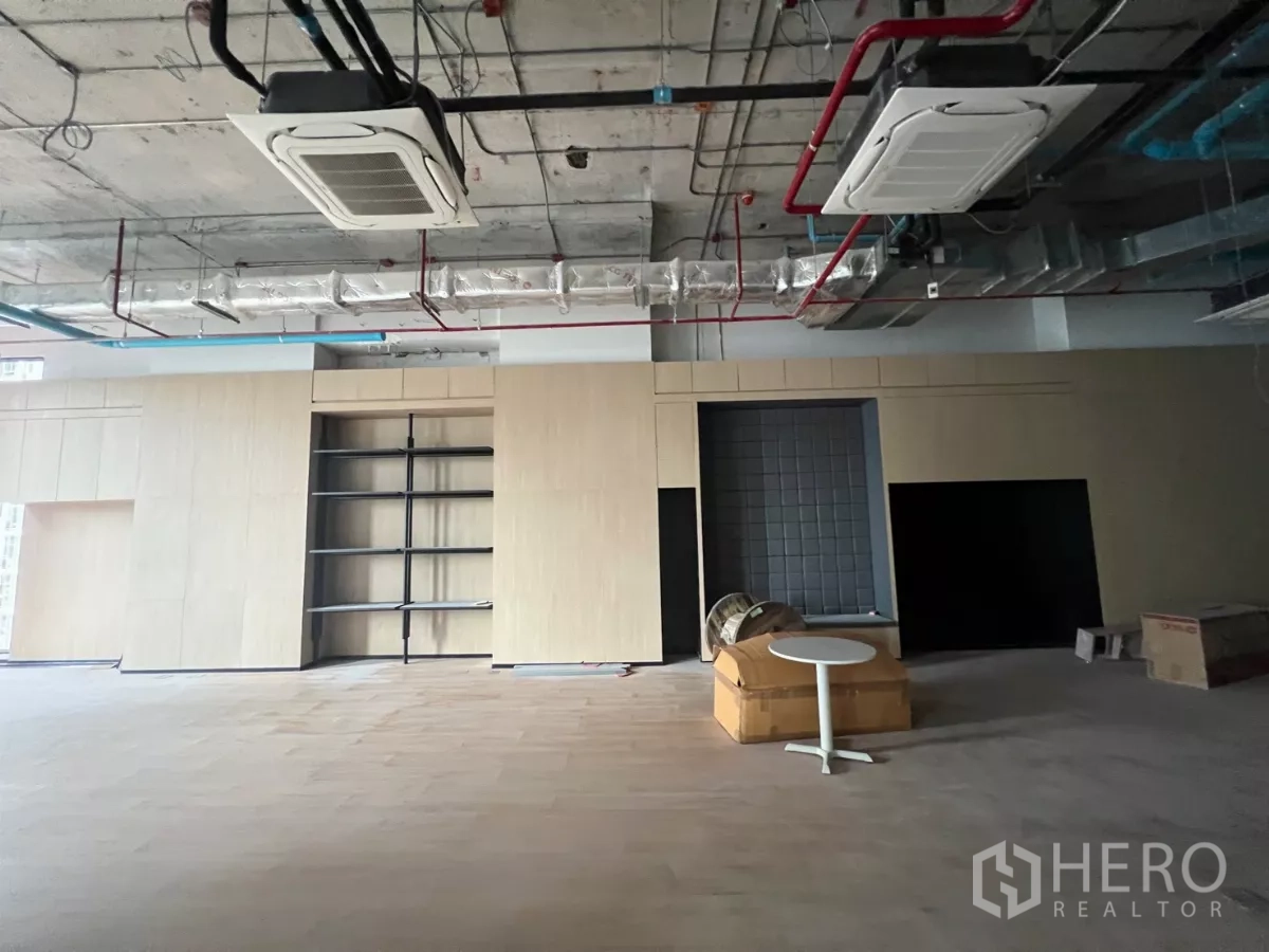 Retail Space for rent - Open-plan retail floor with exposed ducting, wood-look flooring and built-in shelving.