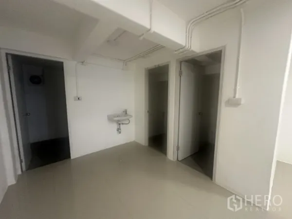 Retail Space for rent - Handwash basin and doors leading to two internal restrooms.