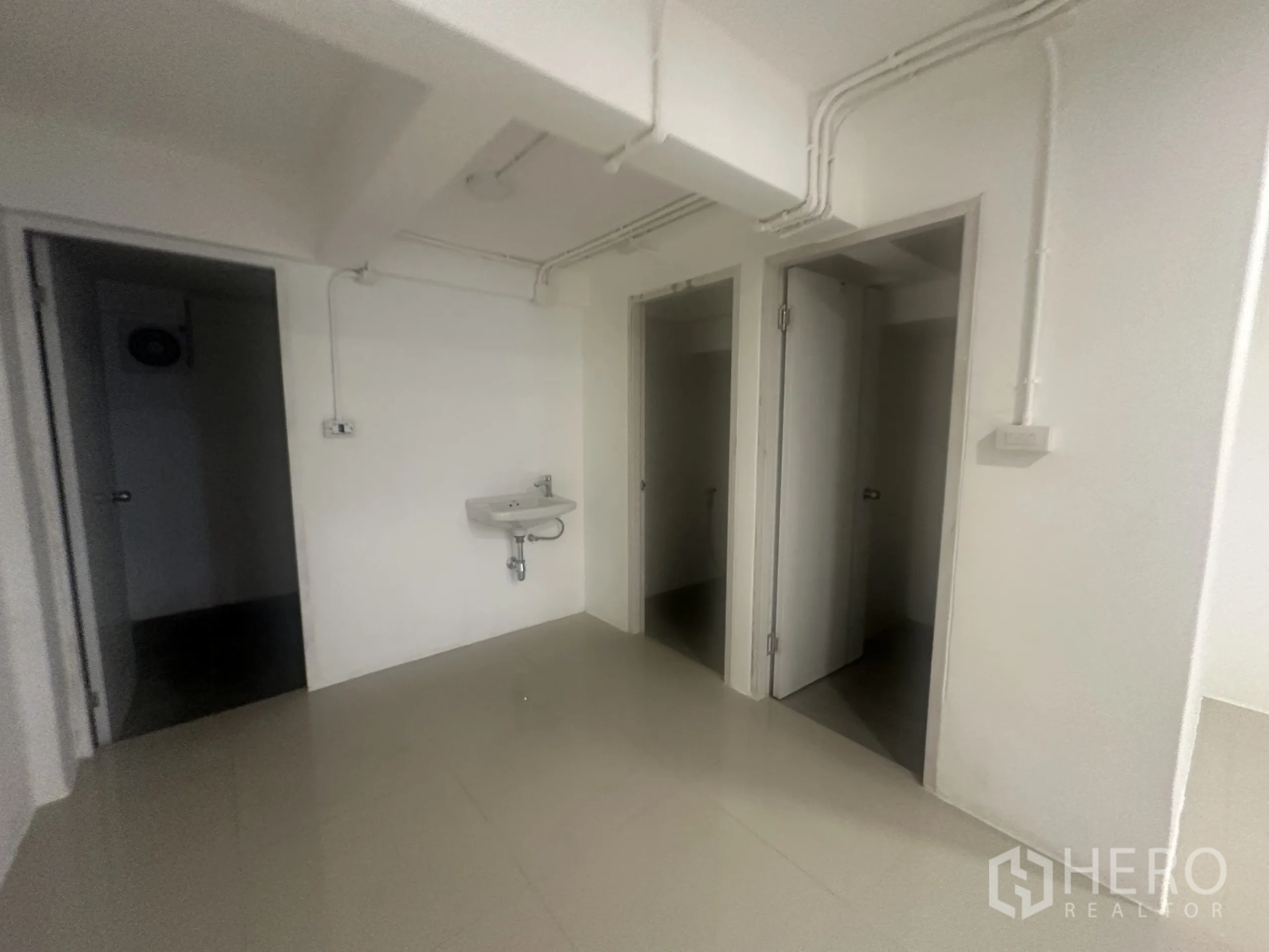 Retail Space for rent - Handwash basin and doors leading to two internal restrooms.