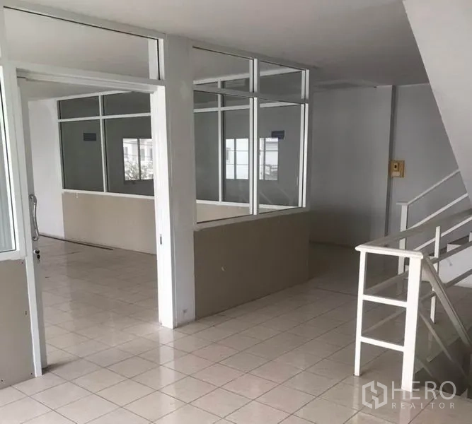 Factory for rent in Bang Bua Thong, Nonthaburi - Office level with glass-partitioned rooms and stair access.