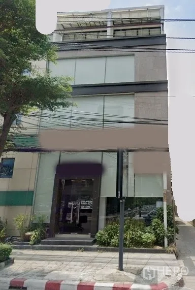 Office Space for rent in Pathum Wan, Bangkok - Modern low-rise commercial building with a glass facade and street frontage in central Bangkok.