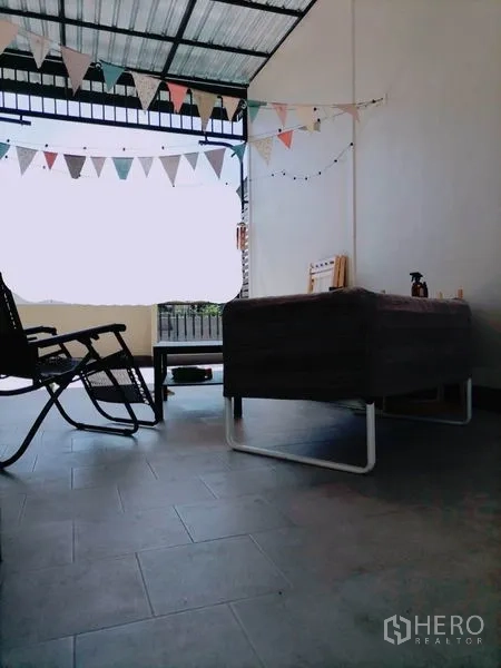 Townhouse for rent or sale in Khlong Toei, Bangkok - Covered terrace with seating and bunting, ideal for relaxing