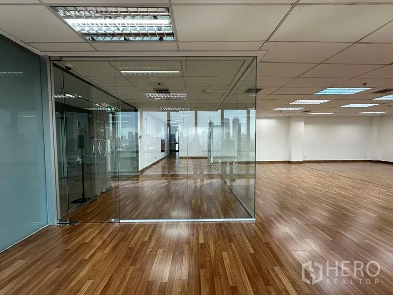 Office Space for rent in Watthana, Bangkok - Open-plan office with wood floors and a glass-walled meeting room in Sukhumvit, Bangkok.