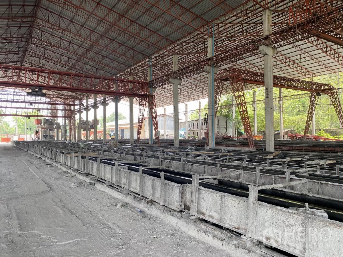 Factory for sale in Chon Buri - Multiple concrete molds and gantry structure running through the manufacturing area.