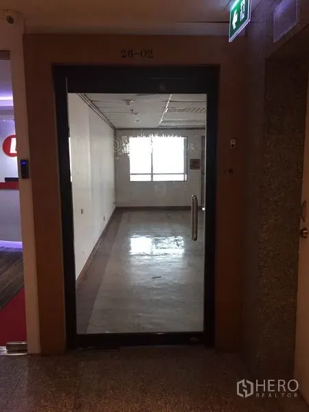Office Space for rent in Watthana, Bangkok - Glass entry door to the office suite with a bright windowed workspace beyond.