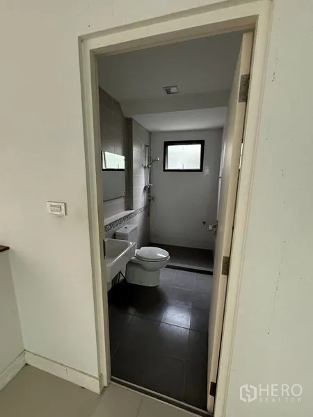 Detached House for rent in Samut Prakan - Bathroom with walk-in shower, white sink and grey floor tiles.