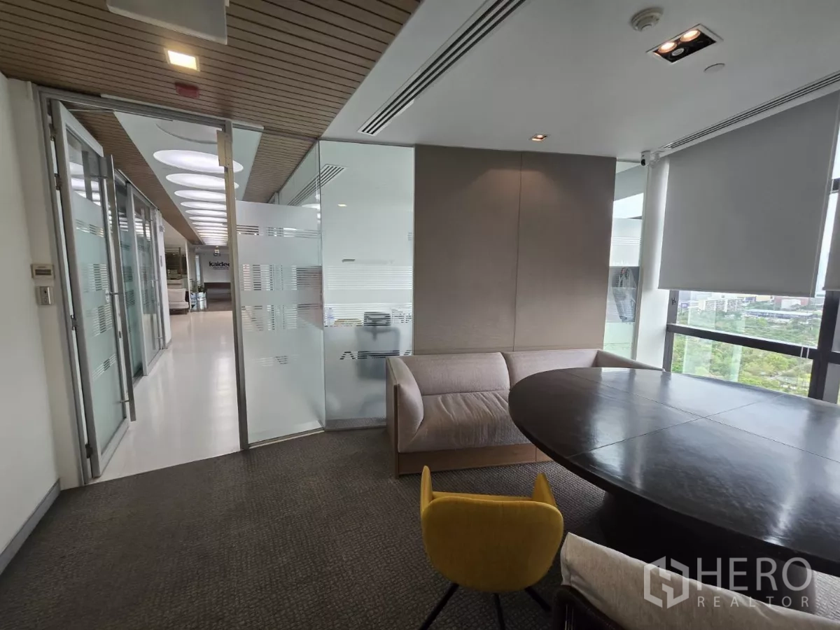 Office Space for rent in Watthana, Bangkok - Small meeting room with round table, sofa seating and city views.