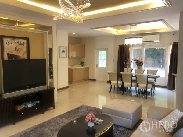 Detached House for rent or sale in Pak Kret, Nonthaburi - Living area with TV console, recessed ceilings and a nearby pantry.