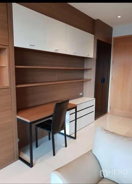 Condominium for rent - Built-in work desk with shelves creating a compact home office in the living area.