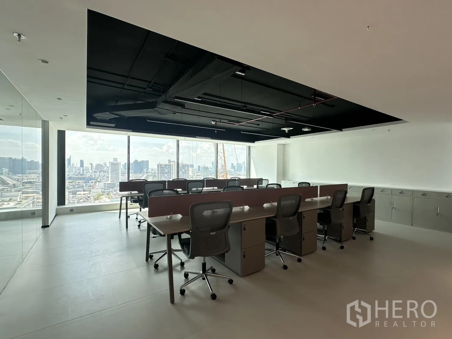 Office Space for rent in Din Daeng, Bangkok - Bright open workspace with long bench desks, exposed black ceiling, and storage cabinets.