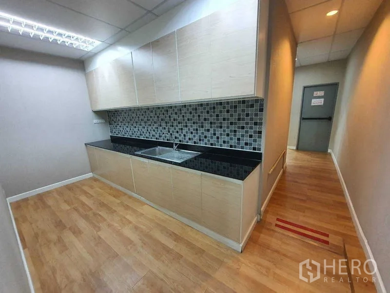 Office Space for rent in Din Daeng, Bangkok - Pantry area with upper and lower cabinets, sink and patterned tile backsplash.