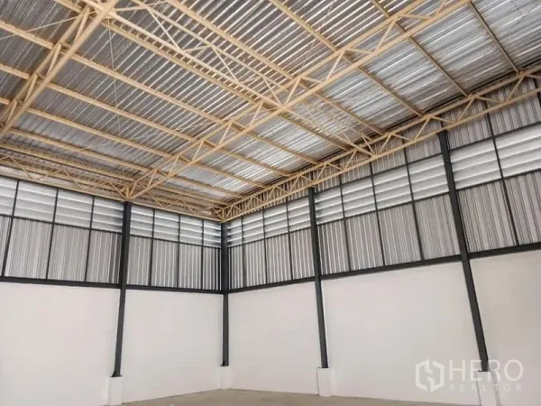 货栈 出租在Suan Luang, Bangkok - 空旷仓内的高挑钢桁架屋顶与百叶墙板，便于通风。