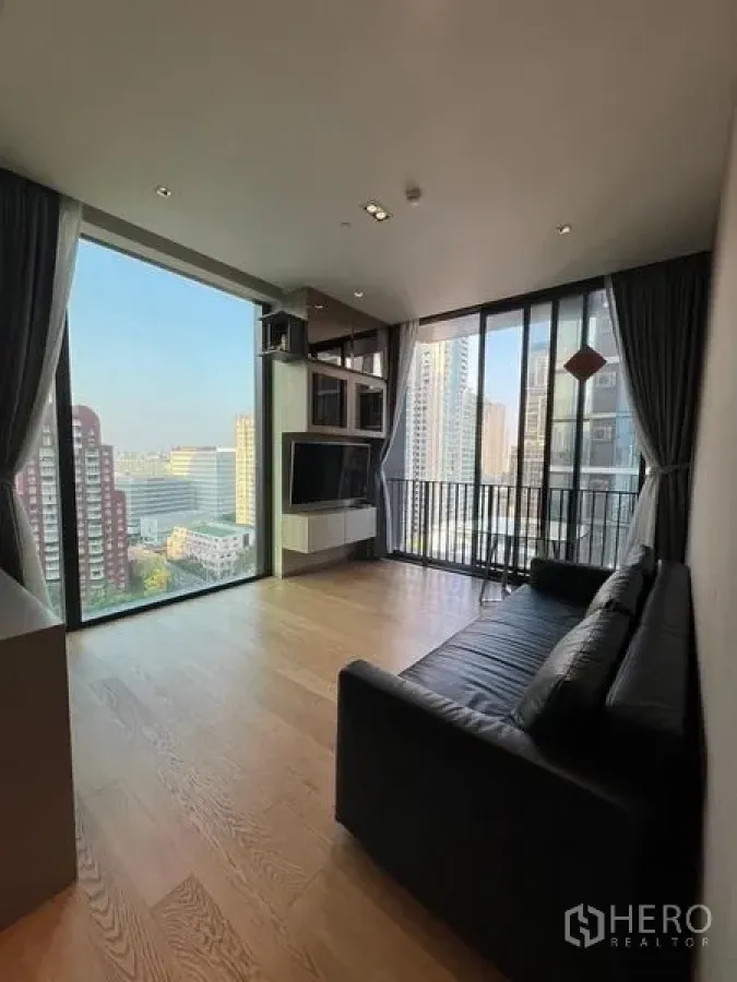 Condominium for rent - Corner living area with panoramic windows and open city view.