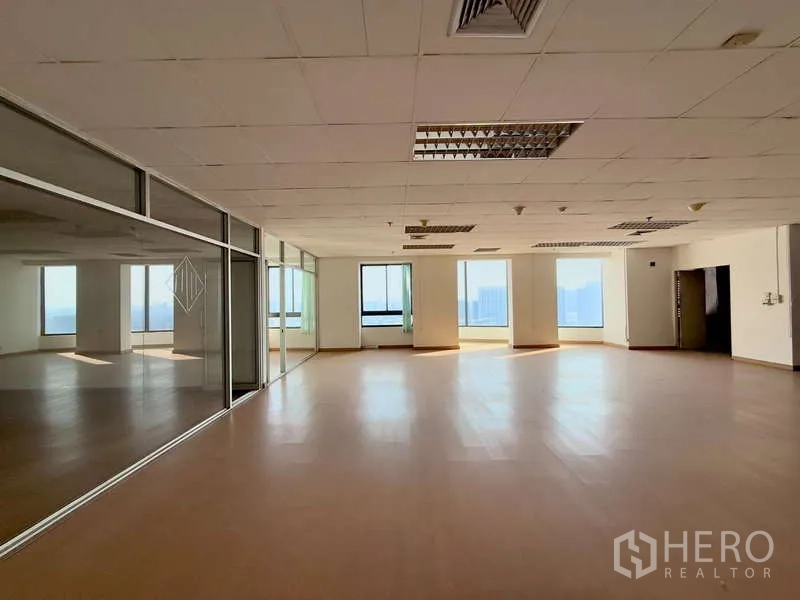 Office Space for rent in Chatuchak, Bangkok - Open workspace with a mirrored glass meeting room and wide windows bringing natural light.