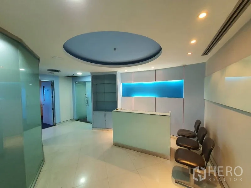 Office Space for rent in Watthana, Bangkok - Reception foyer with blue backlit feature wall and visitor seating.