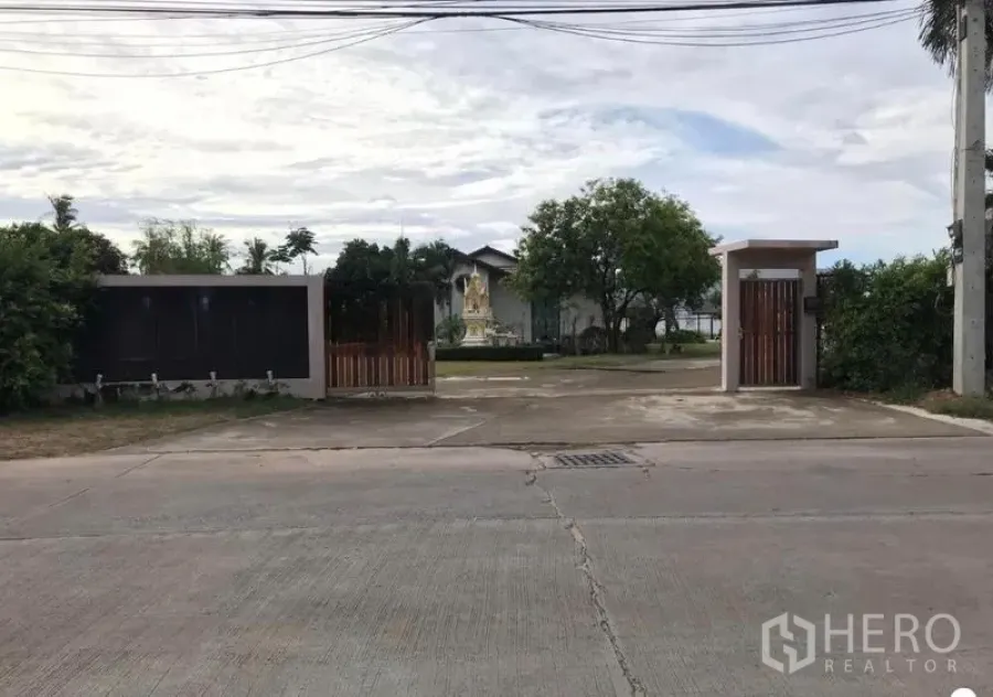 คลังสินค้า ขายในChon Buri - ประตูหน้าโครงการติดถนนสาธารณะ พร้อมซุ้มทางเข้าและสายไฟเหนือศีรษะ