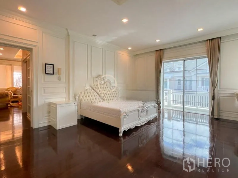 Detached House for rent in Bang Phli, Samut Prakan - Spacious master bedroom with ornate white bed and sliding doors to the balcony