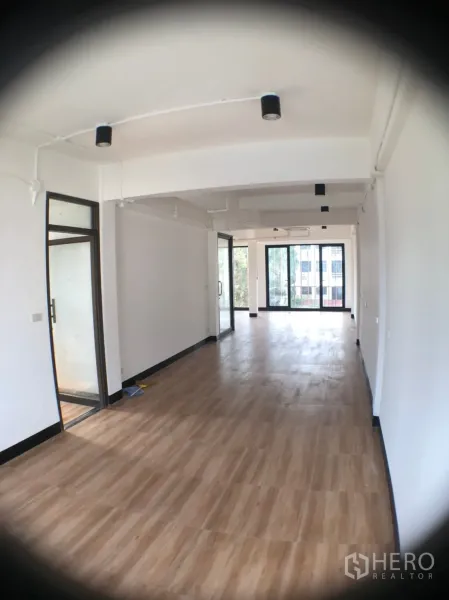 Home Office for rent in Phra Khanong, Bangkok - Long open-plan office floor with wood-look tiles, white walls and sliding glass doors.