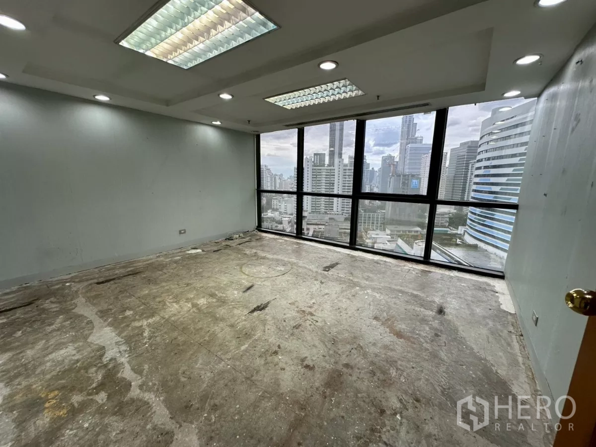 Office Space for rent in Khlong Toei, Bangkok - Corner office with floor-to-ceiling windows offering Bangkok skyline views.