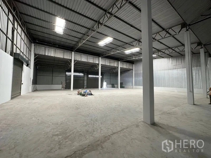 Warehouse for rent in Khlong Luang, Pathum Thani - Wide clear-span interior with steel columns, corrugated walls, and ample floor space.