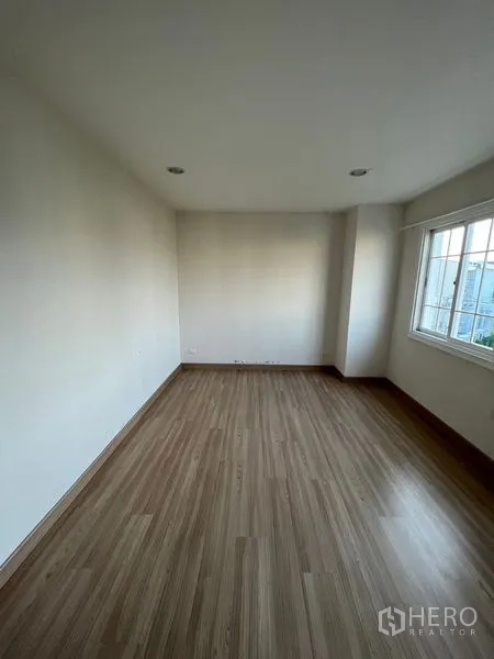 Home Office for rent or sale - Rectangular room with wood floor and corner window, ready for office setup.