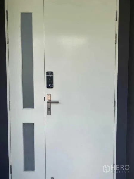 Detached House for rent in Khan Na Yao, Bangkok - Close‑up of secure front door with smart digital lock and frosted glass panels.