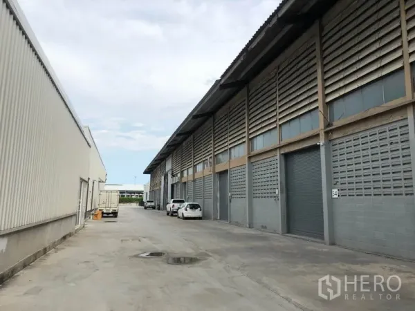 โรงงาน ให้เช่าในMueang Samut Prakan, Samut Prakan - ด้านหน้าอาคารอุตสาหกรรม ประตูม้วน และถนนกว้างสำหรับรถบรรทุก