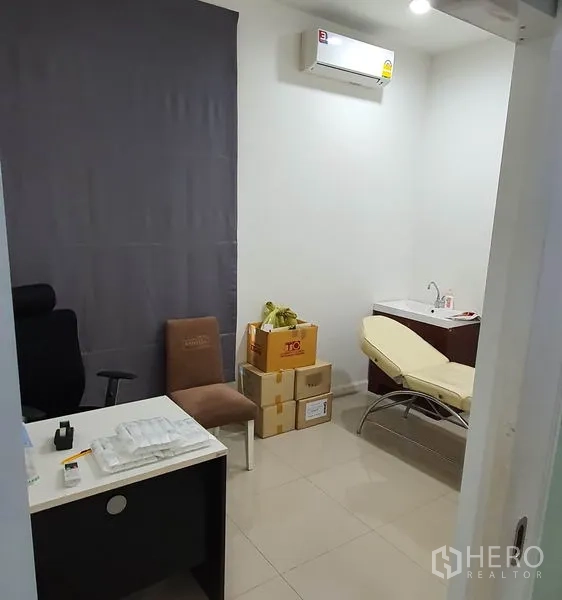 Home Office for rent in Chatuchak, Bangkok - Private treatment room with desk, sink and examination bed in an air-conditioned space.