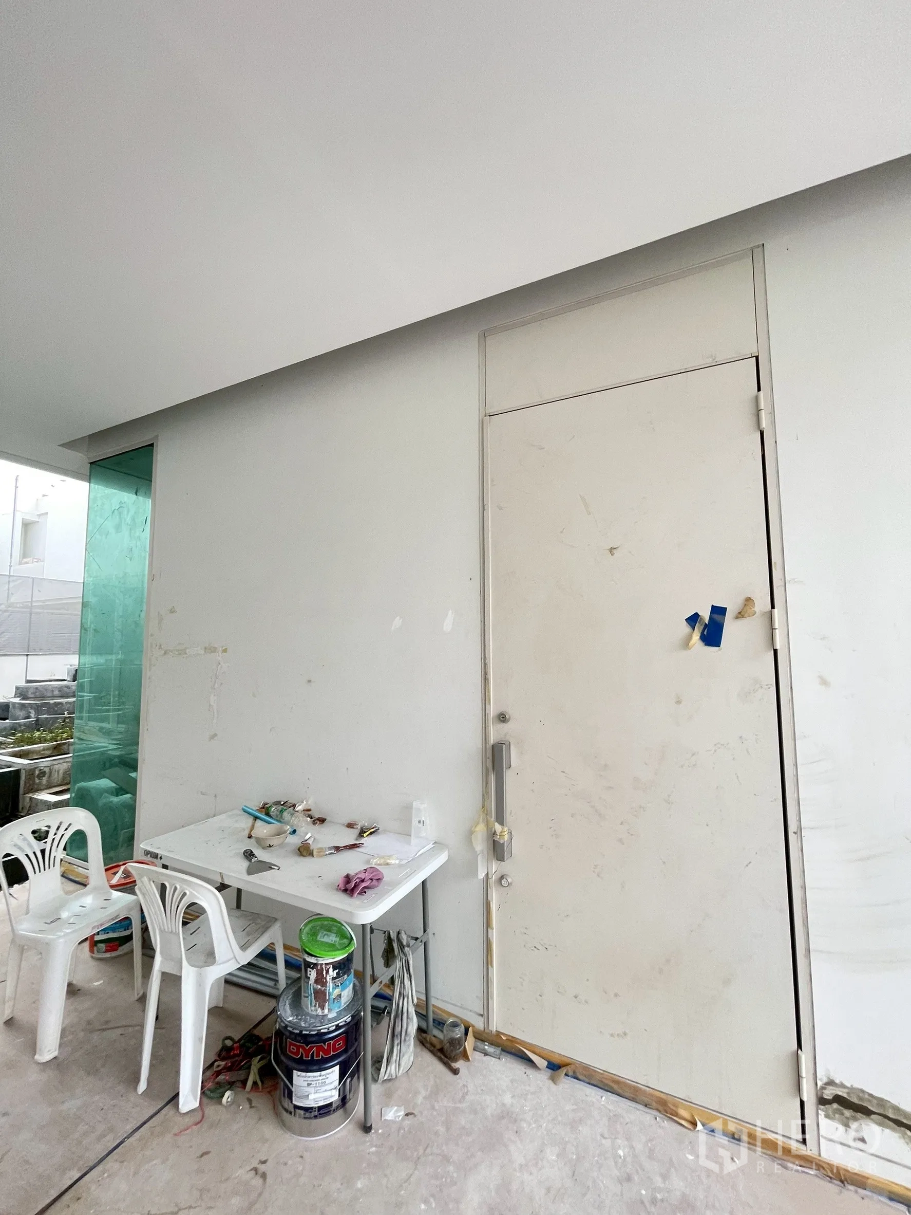Detached House for sale in Bang Phli, Samut Prakan - Side entry door next to a temporary worktable and tools on site.