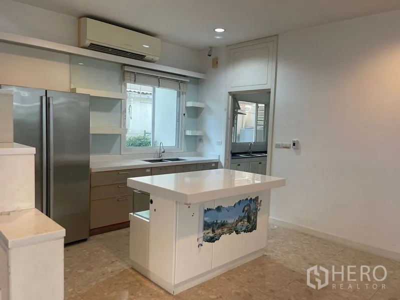 Detached House for rent or sale in Khan Na Yao, Bangkok - Bright modern kitchen with central island, built-in cabinetry and a double-door refrigerator.