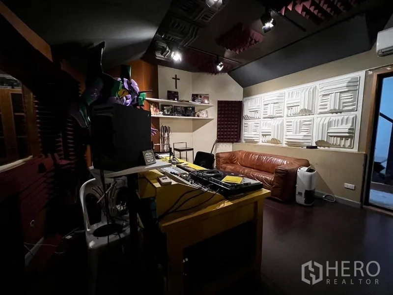 Townhouse for rent - Acoustic studio control room with equipment rack and leather sofa.
