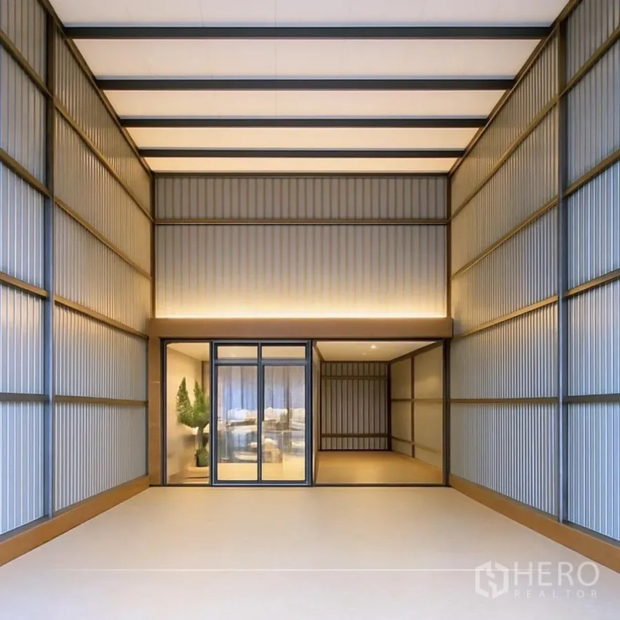 Warehouse for rent in Suan Luang, Bangkok - Modern high-ceiling warehouse bay with warm strip lighting and a glass-front office at the rear.