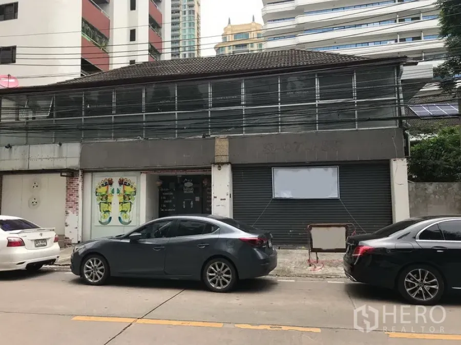 Retail Space for rent in Watthana, Bangkok - Two-storey shophouse-style retail frontage with roller shutters, glass entry and street parking in Sukhumvit.