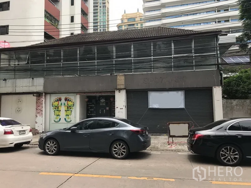 Retail Space for rent in Watthana, Bangkok - Two-storey shophouse-style retail frontage with roller shutters, glass entry and street parking in Sukhumvit.