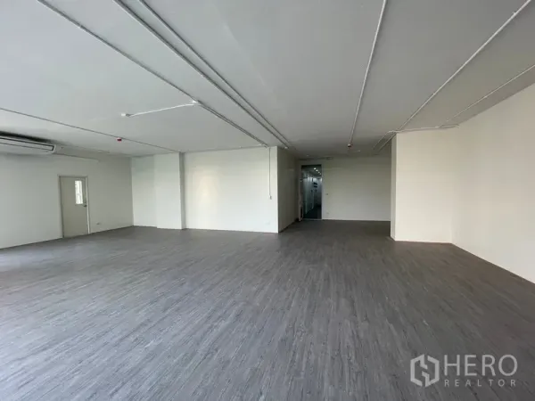 Office Space for rent in Bang Rak, Bangkok - Wide office area showing doorway to the service core and generous ceiling height.