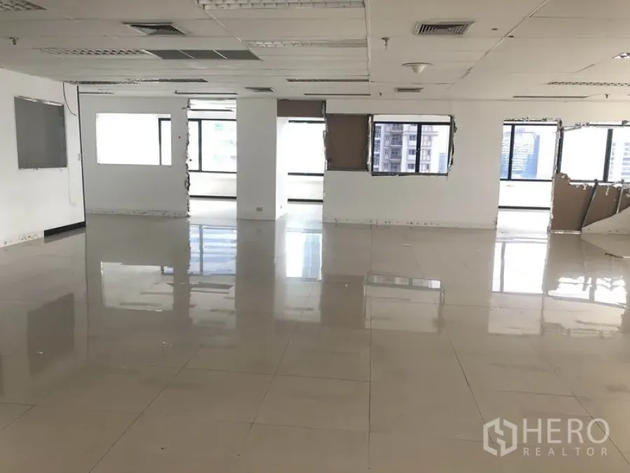 Office Space for rent in Watthana, Bangkok - Large empty office floor with drop ceiling and wraparound windows.