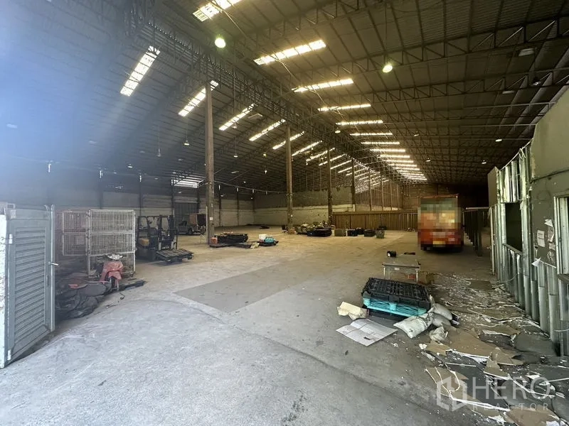 货栈 出租在Suan Luang, Bangkok - 仓库内部空间宽敞，钢结构高挑屋顶与天窗，卡车可直接驶入装卸区。