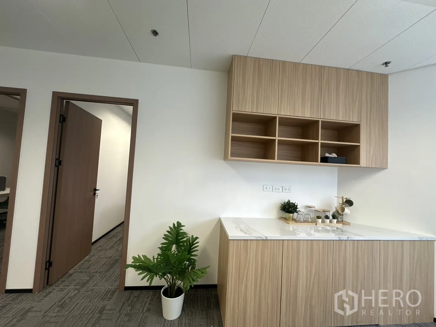 Office Space for rent in Pathum Wan, Bangkok - Pantry area with marble countertop and wood cabinets.