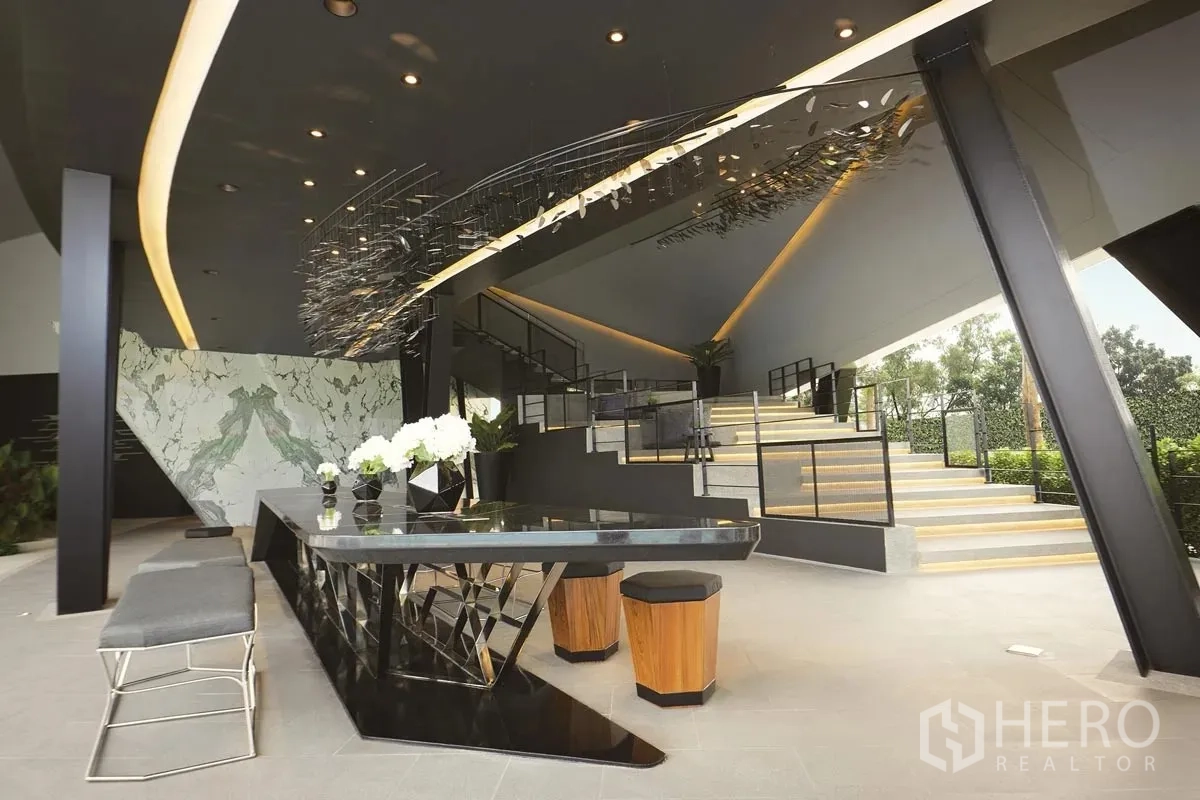 Detached House for rent or sale in Pathum Thani - Clubhouse lobby featuring designer ceiling, stairs and modern furnishings.
