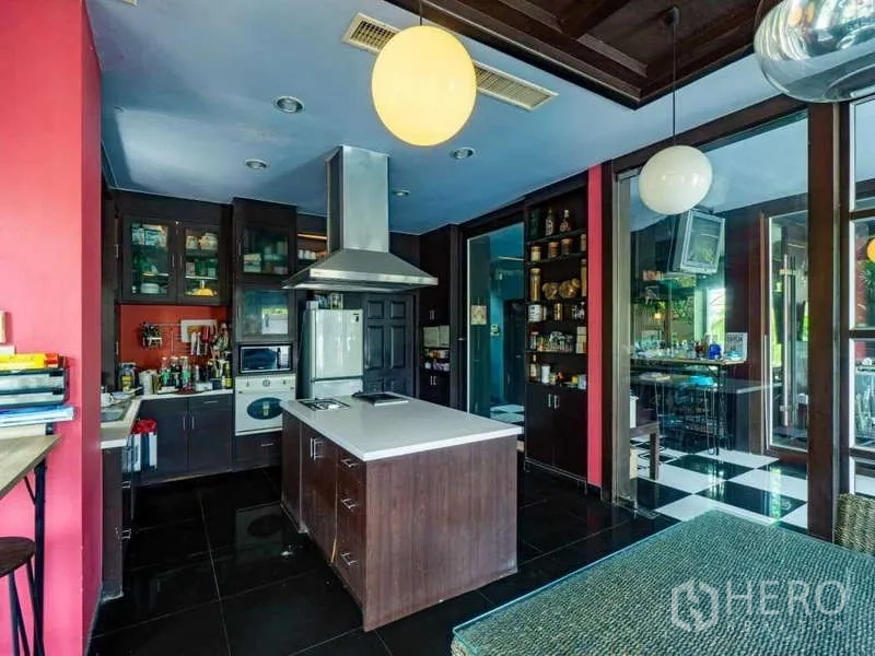 Detached House for sale in Suan Luang, Bangkok - Fitted kitchen with central island, range hood and dark cabinetry.