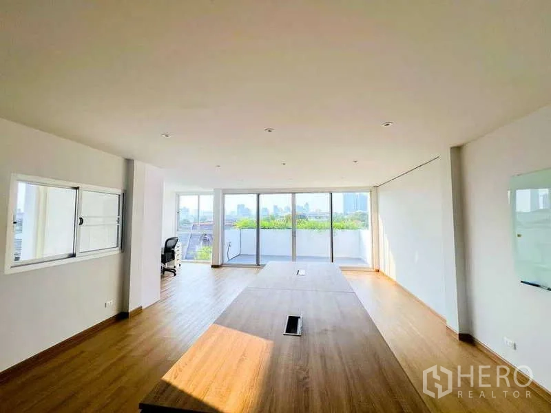 Home Office for rent in Phra Khanong, Bangkok - Large meeting room with wood flooring, floor-to-ceiling windows and terrace greenery with city view.