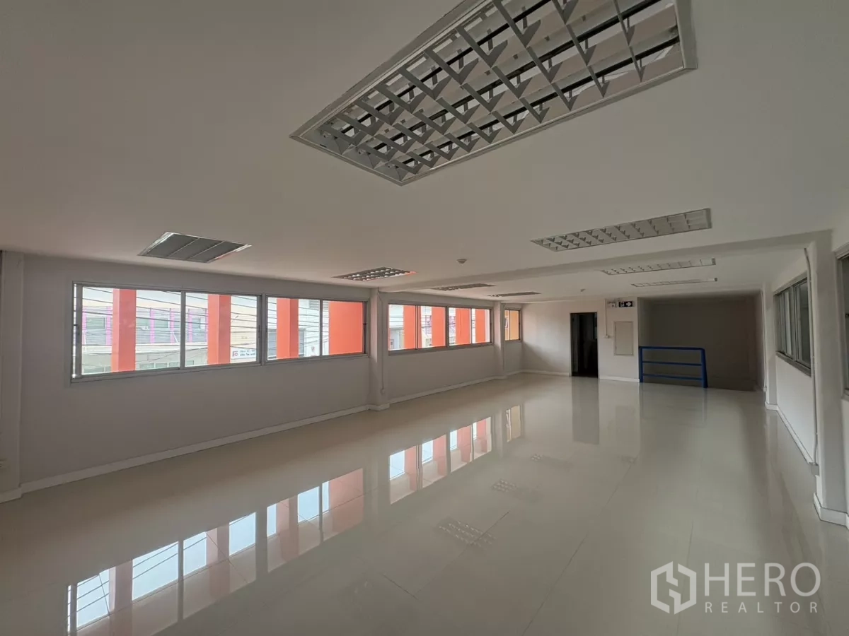 Factory for rent in Bang Phli, Samut Prakan - Bright mezzanine office level with ceiling lights and window wall overlooking the site.