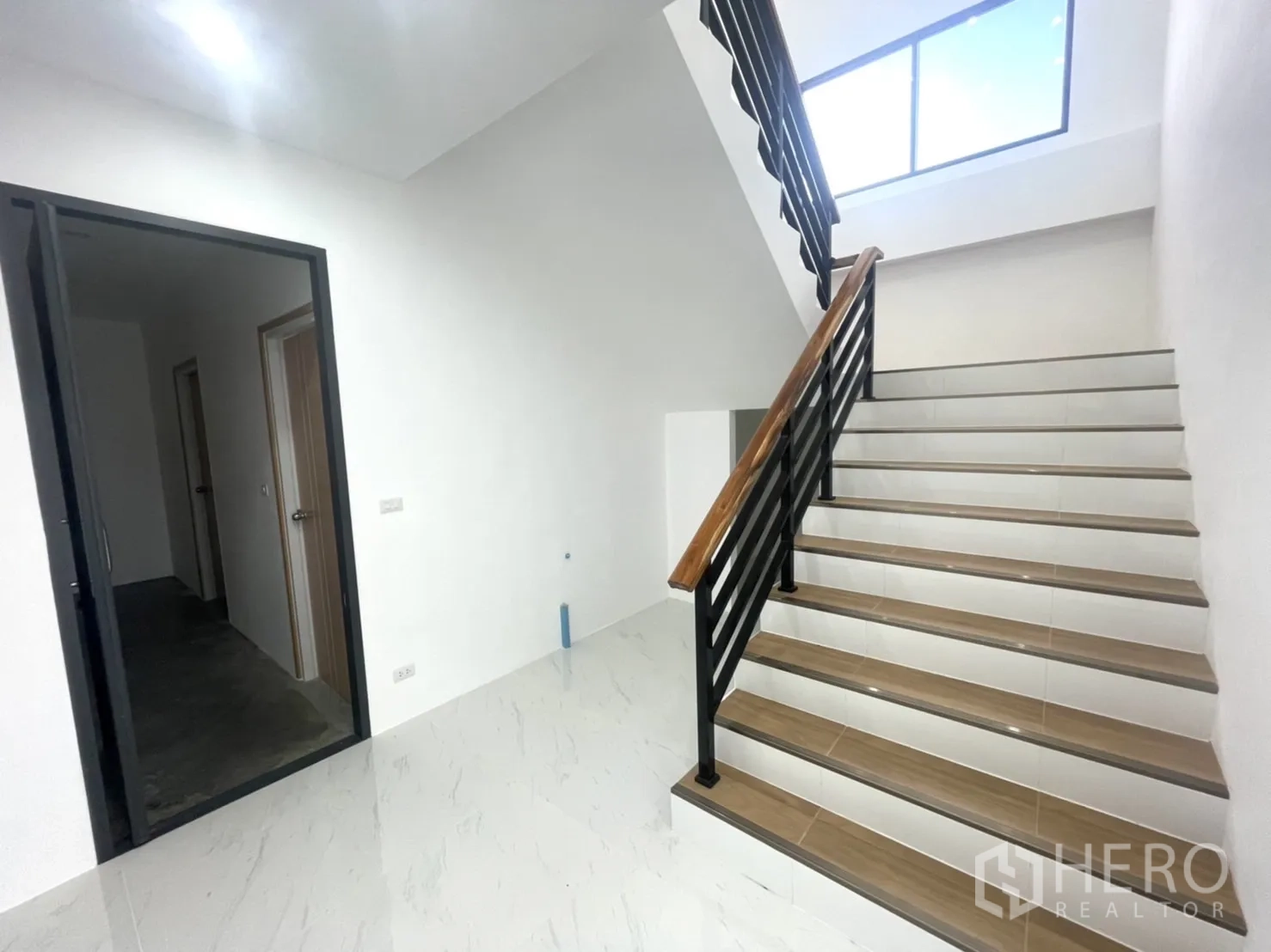 Factory for rent or sale in Bang Yai, Nonthaburi - Clean stairwell with wood handrail and black metal balustrade leading to office spaces.