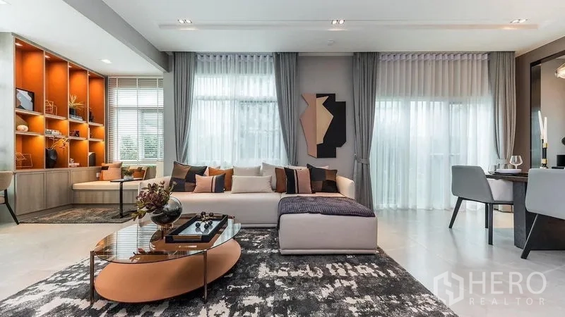 บ้าน ให้เช่าในPrawet, Bangkok - ห้องนั่งเล่นมองไปยังชั้นโชว์และหน้าต่างสูงจรดเพดานพร้อมม่านโปร่ง