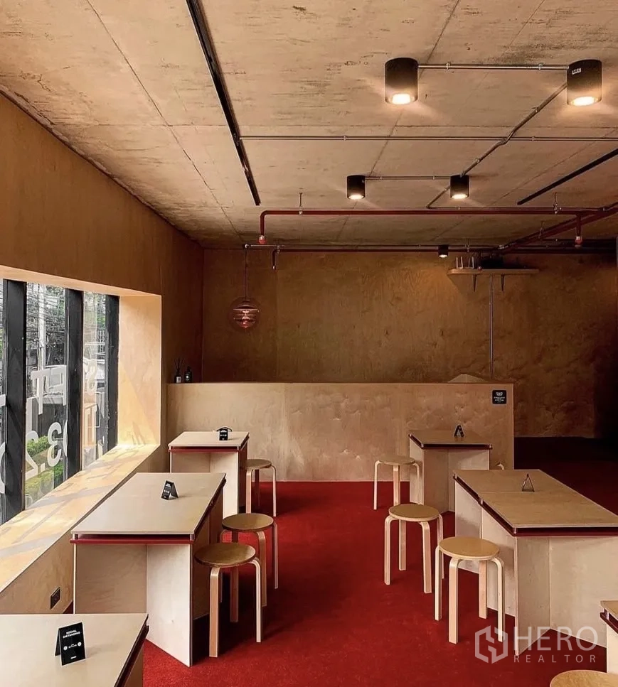 Retail Space for rent in Watthana, Bangkok - Cafe-style seating area with pendant lights and plywood finishes.