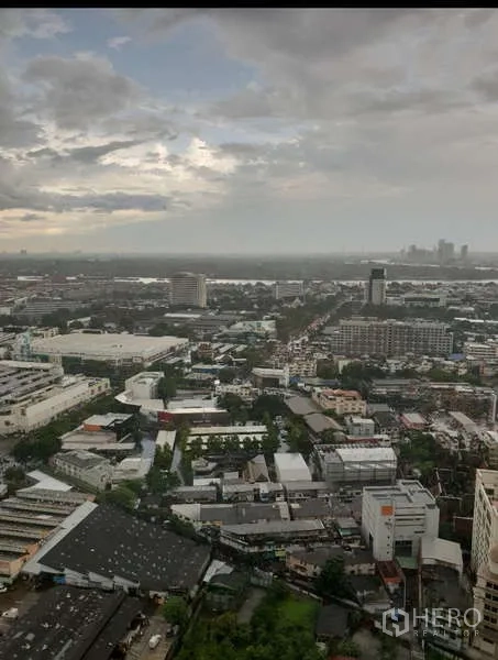 Condominium for rent - High-floor urban panorama over Bangkok under a cloudy sky.