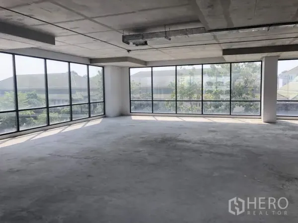 Office Space for rent in Suan Luang, Bangkok - Corner office zone with panoramic glass walls overlooking greenery, ready for tenant fit-out.