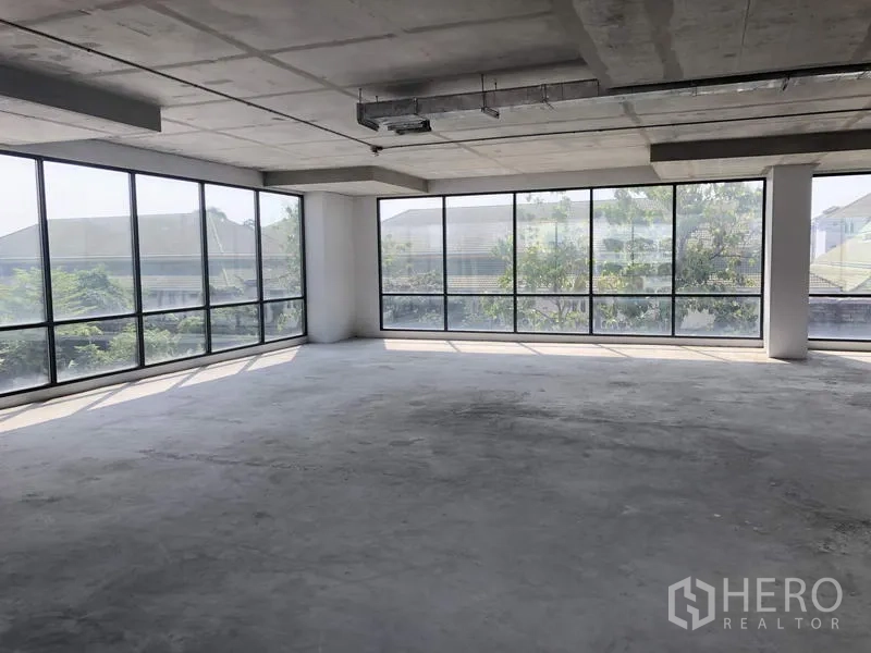 Office Space for rent in Suan Luang, Bangkok - Corner office zone with panoramic glass walls overlooking greenery, ready for tenant fit-out.